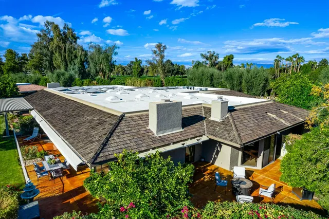 an aerial view of a house with a yard