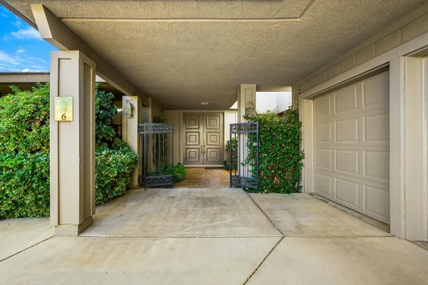 a view of a house with a yard and patio