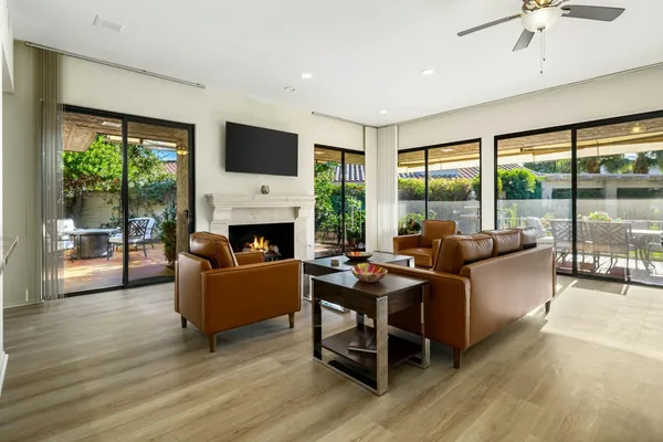 a living room with fireplace furniture and a flat screen tv