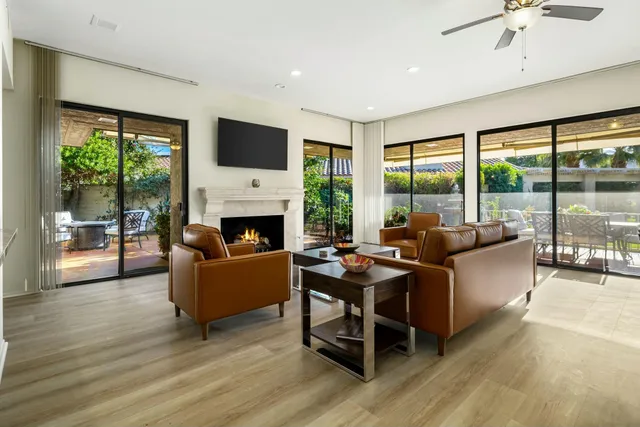 a living room with fireplace furniture and a flat screen tv