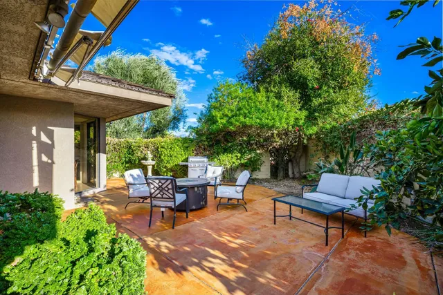 a backyard of a house with outdoor seating