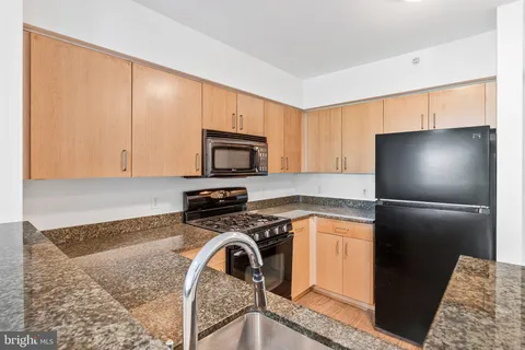 a kitchen with a refrigerator stove and microwave