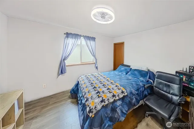 a bedroom with a bed and a window