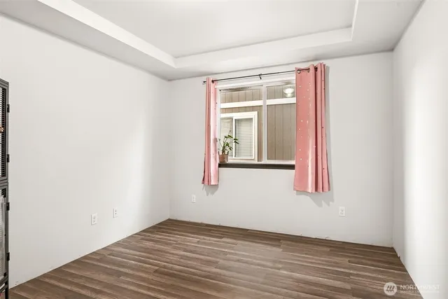 a view of a small space with wooden floor and a window