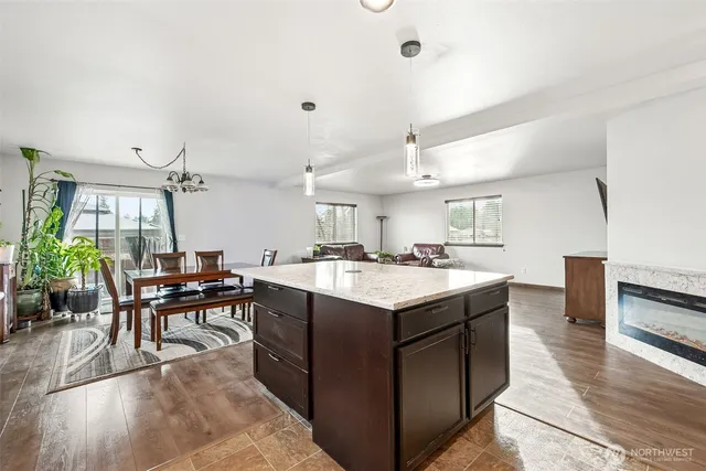 a kitchen with a dining table chairs stove and cabinets