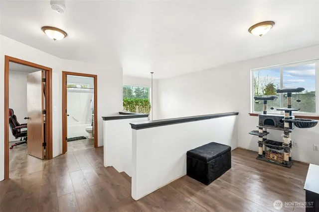a hallway with wooden floor and furniture
