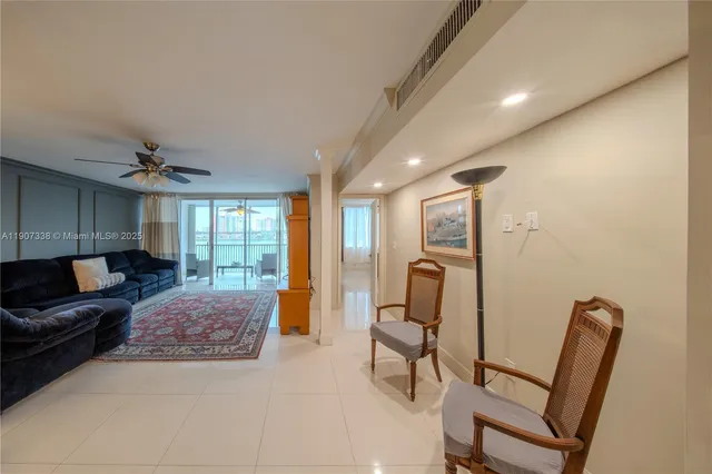 a spacious bedroom with a bed a couch and large window