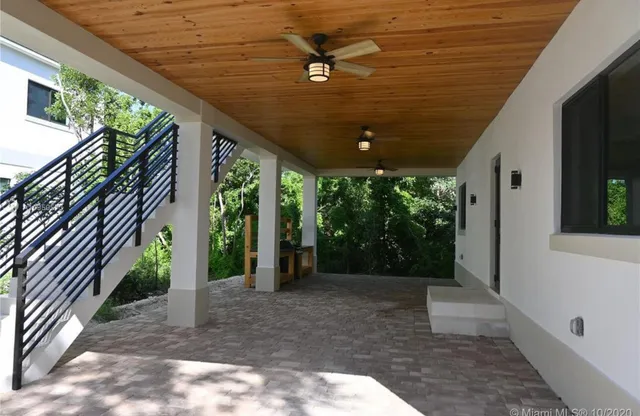 an empty room with closet and fan