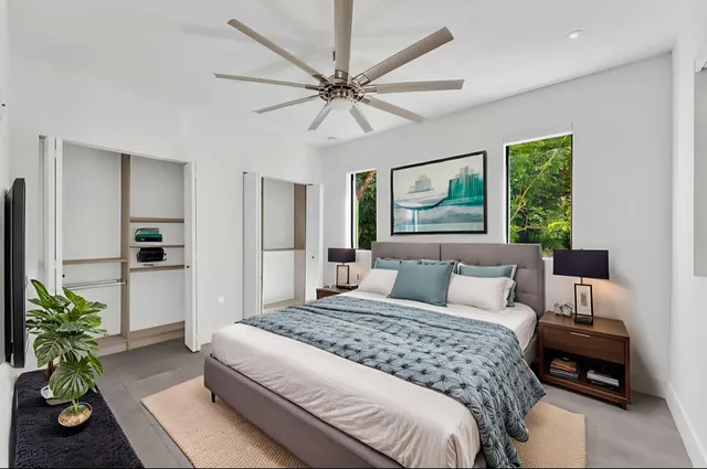 an empty room with closet and fan