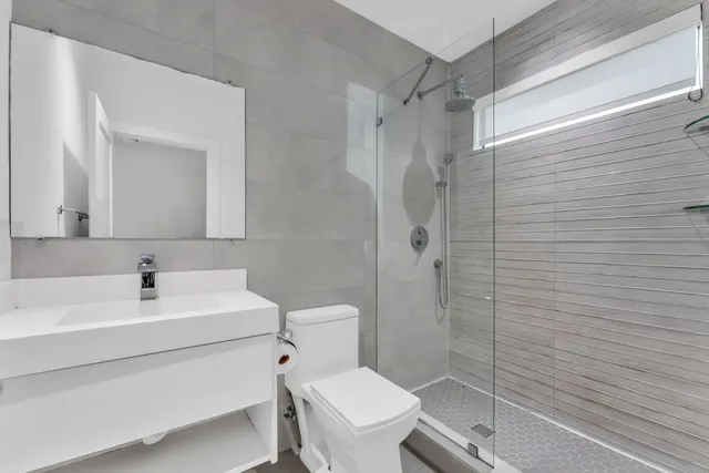 a kitchen with white cabinets stainless steel appliances and sink