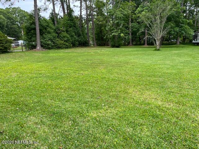 a view of a field with trees in the background