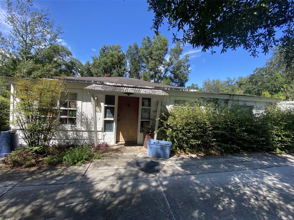 11708 Hills Road Seffner, FL 33584 - Photo 13 of 30 a front view of a house with a yard and potted plants