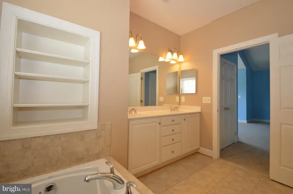 a bathroom with a sink a vanity and a mirror