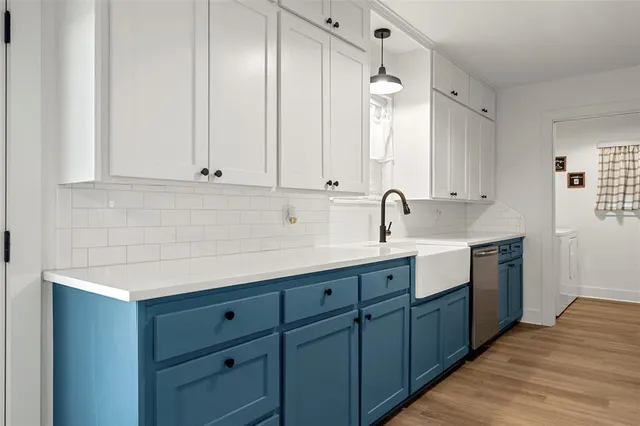 a kitchen with a sink and cabinets