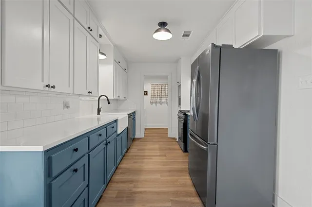a kitchen with stainless steel appliances a refrigerator and cabinets