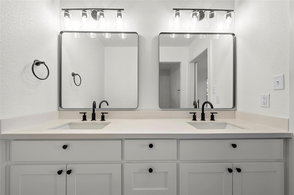 175 4 Corners Road West, TX 76691 - Photo 14 of 30 a bathroom with double vanity sinks and a mirror