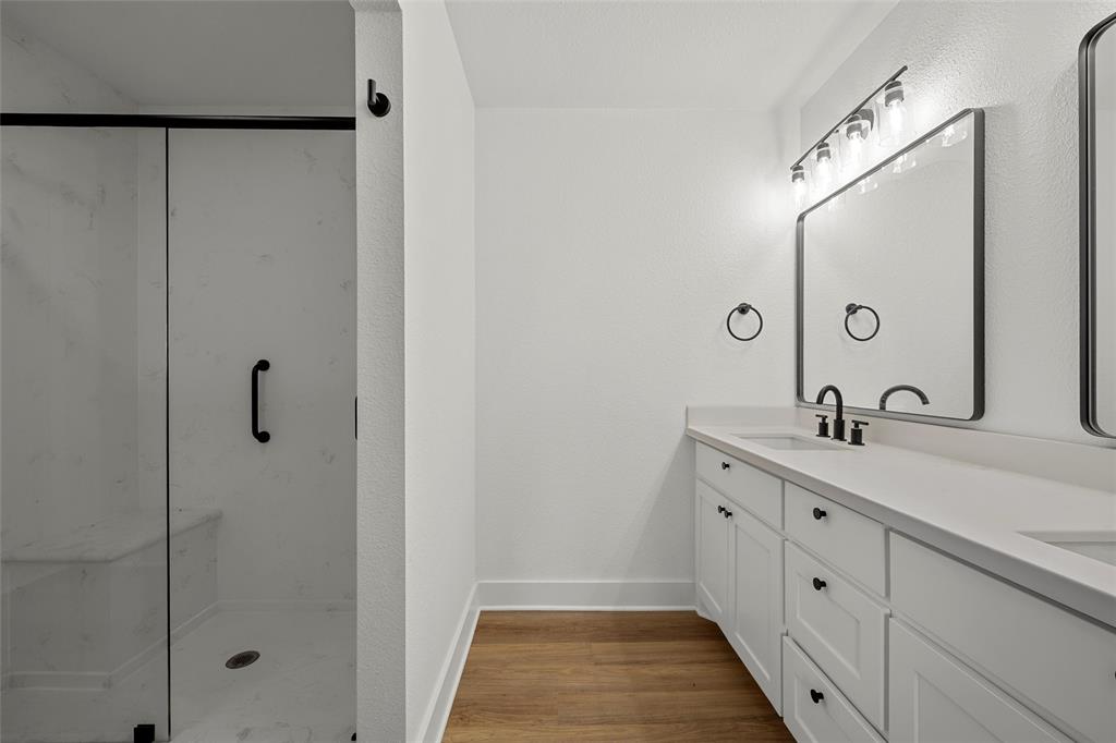 175 4 Corners Road West, TX 76691 - Photo 19 of 30 a bathroom with a double vanity sink and mirror