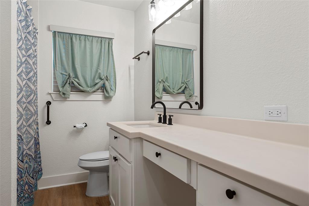 175 4 Corners Road West, TX 76691 - Photo 21 of 30 a bathroom with a sink a toilet and a mirror