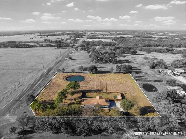an aerial view of residential building and lake