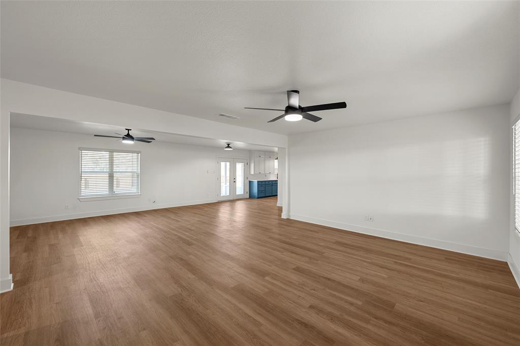 175 4 Corners Road West, TX 76691 - Photo 4 of 30 a view of empty room with wooden floor and fan