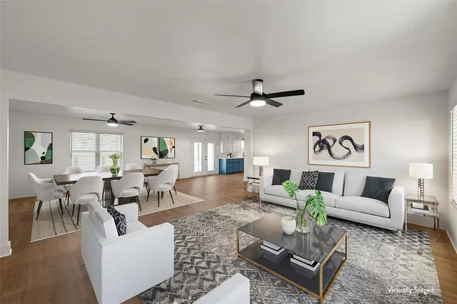 a living room with furniture and a view of kitchen