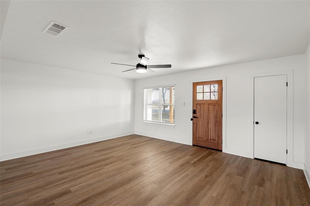 175 4 Corners Road West, TX 76691 - Photo 6 of 30 a view of an empty room with wooden floor and a window