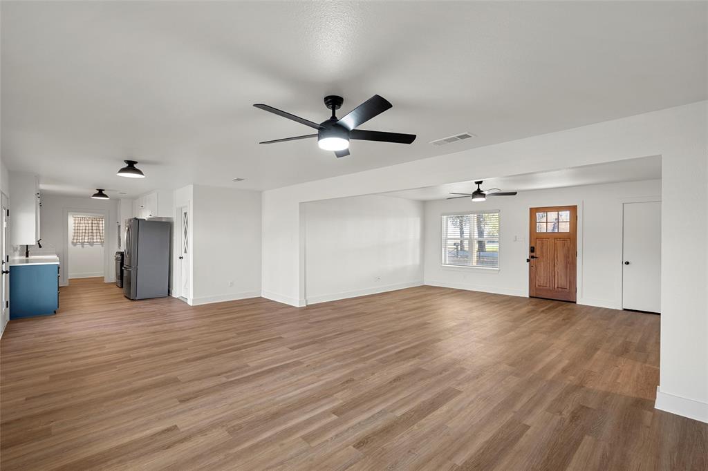 175 4 Corners Road West, TX 76691 - Photo 9 of 30 a view of an empty room with window and wooden floor