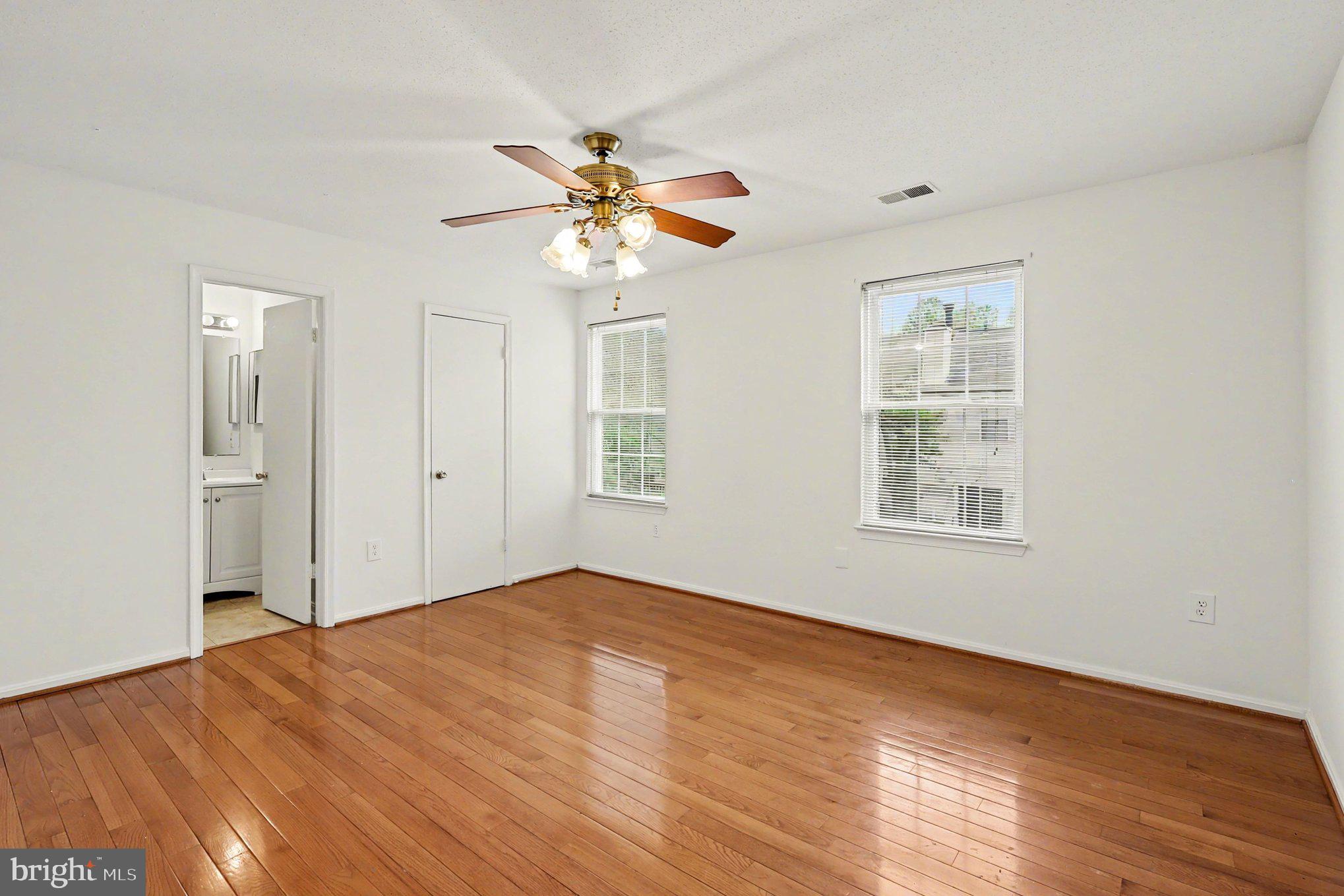14721 McKnew Road Burtonsville, MD 20866 - Photo 11 of 30 a view of empty room with wooden floor and fan