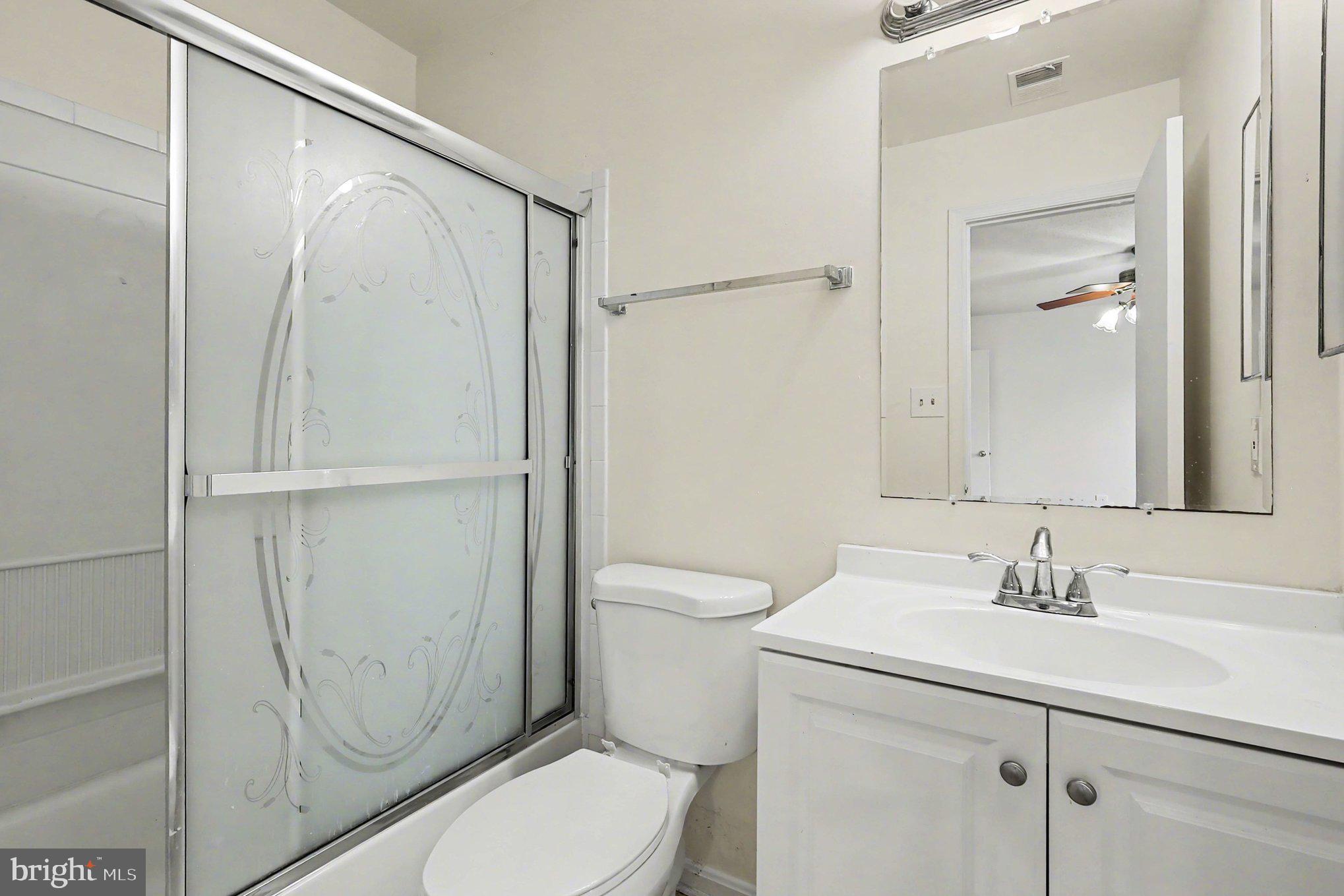 14721 McKnew Road Burtonsville, MD 20866 - Photo 13 of 30 a bathroom with a sink a toilet and shower