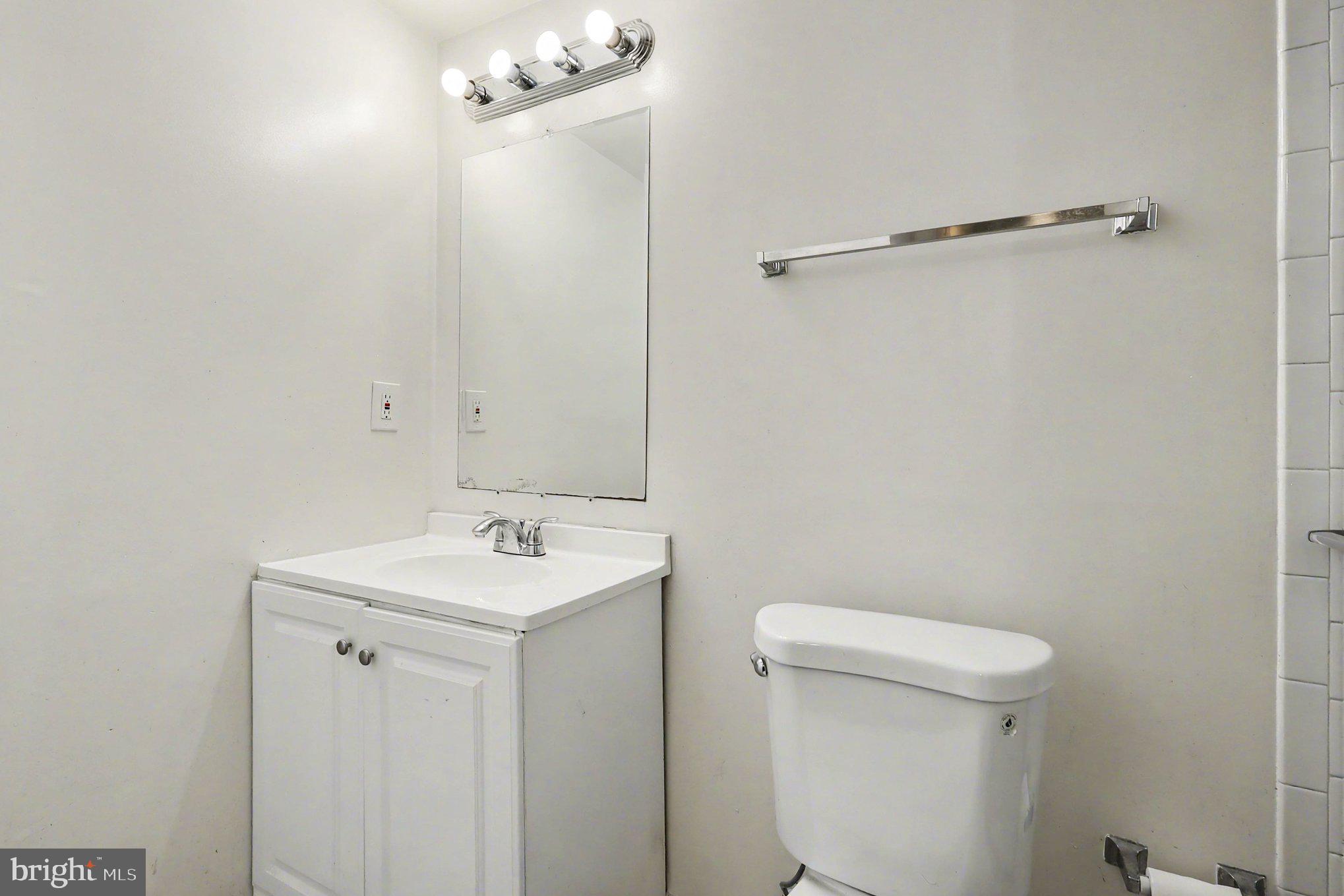 14721 McKnew Road Burtonsville, MD 20866 - Photo 16 of 30 a bathroom with a sink a toilet and a mirror