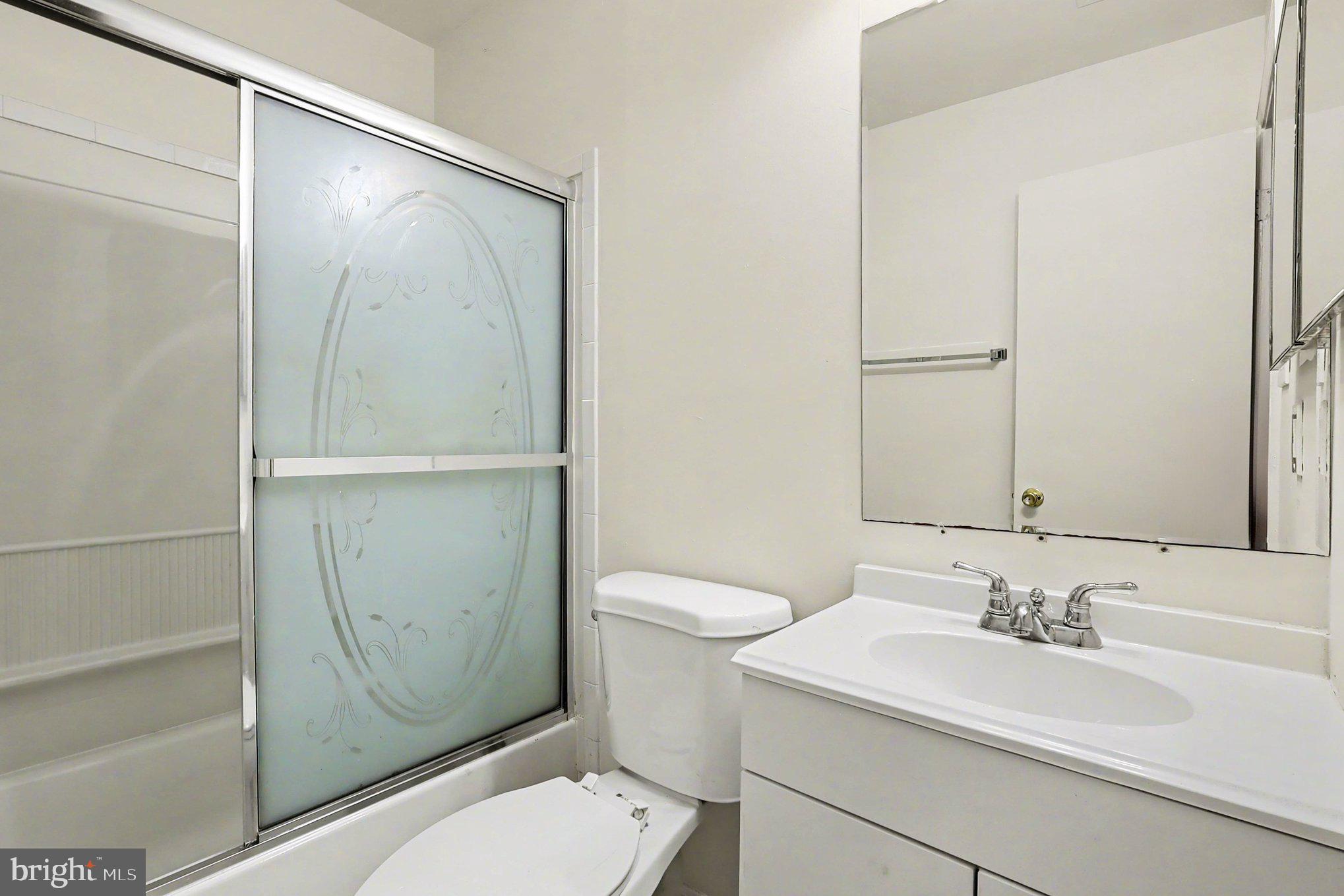 14721 McKnew Road Burtonsville, MD 20866 - Photo 17 of 30 a bathroom with a sink toilet and shower