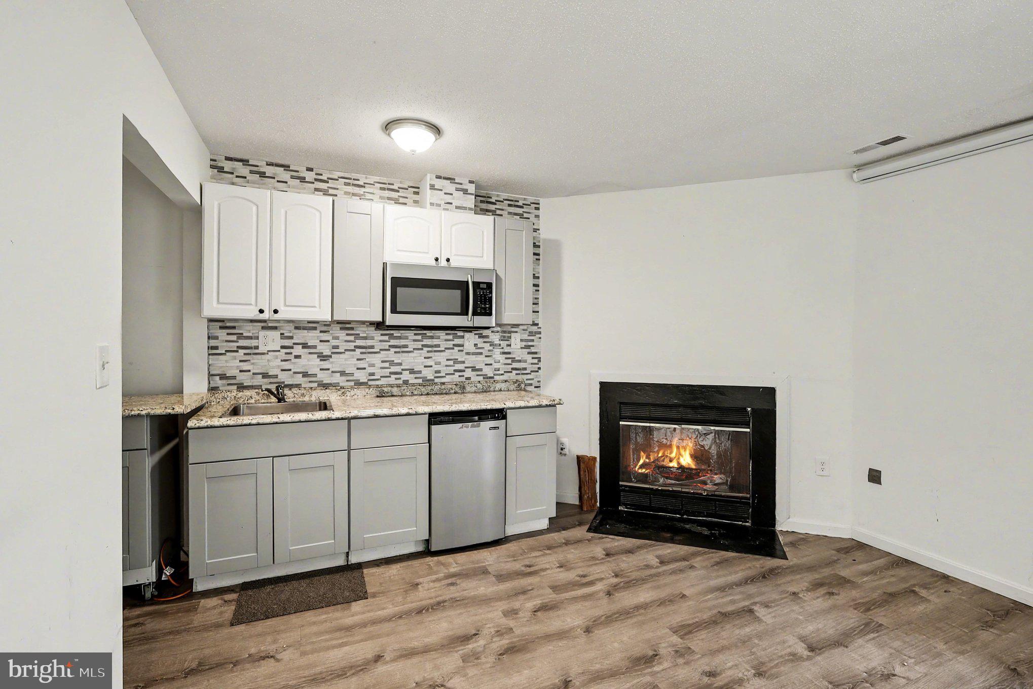 14721 McKnew Road Burtonsville, MD 20866 - Photo 21 of 30 a kitchen with stainless steel appliances granite countertop a stove a sink and a microwave