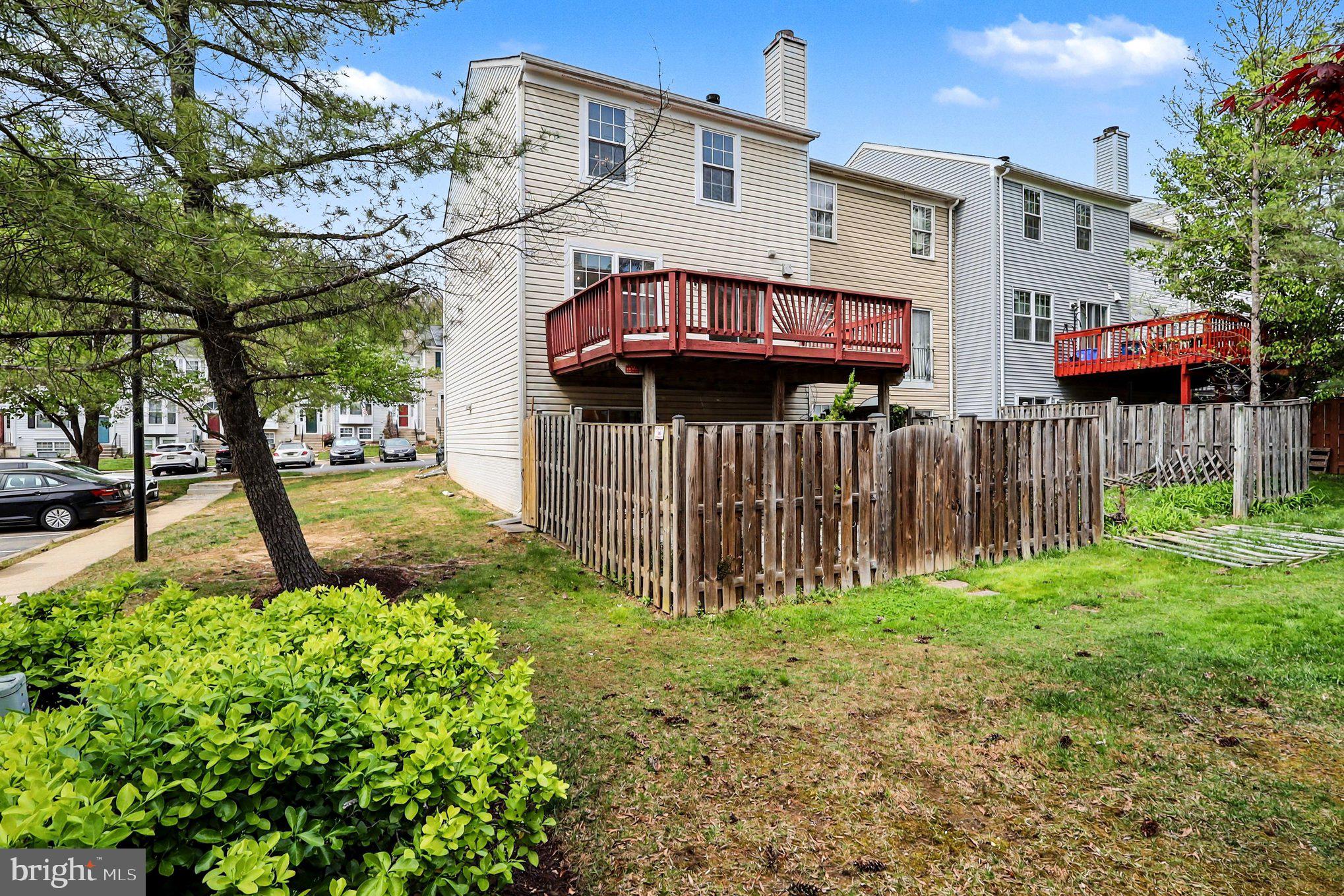 14721 McKnew Road Burtonsville, MD 20866 - Photo 26 of 30 a view of a house with a small yard and wooden fence