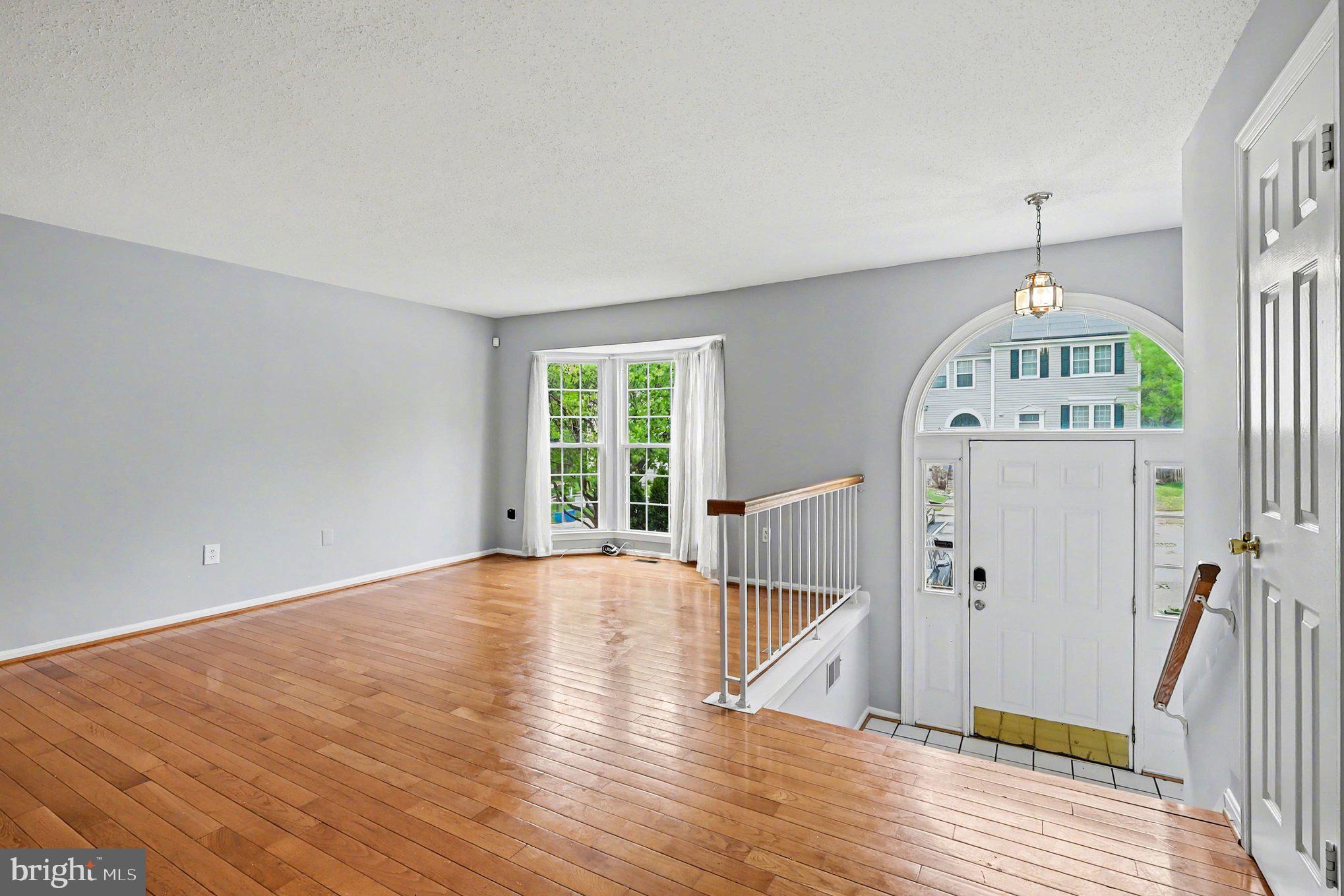 14721 McKnew Road Burtonsville, MD 20866 - Photo 4 of 30 wooden floor in an empty room with a window