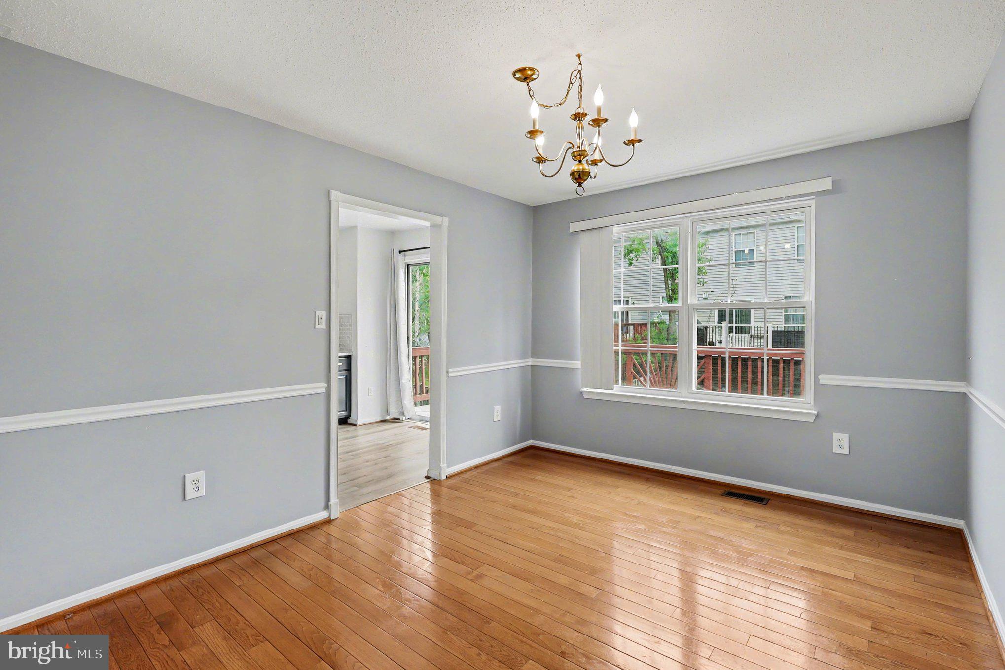 14721 McKnew Road Burtonsville, MD 20866 - Photo 6 of 30 a view of an empty room with wooden floor and a window