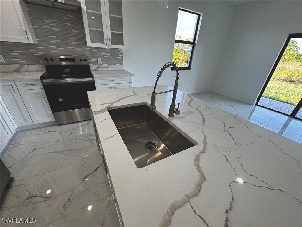 7016 Tide Circle LaBelle, FL 33935 - Photo 11 of 47 a kitchen that has a sink and a stove