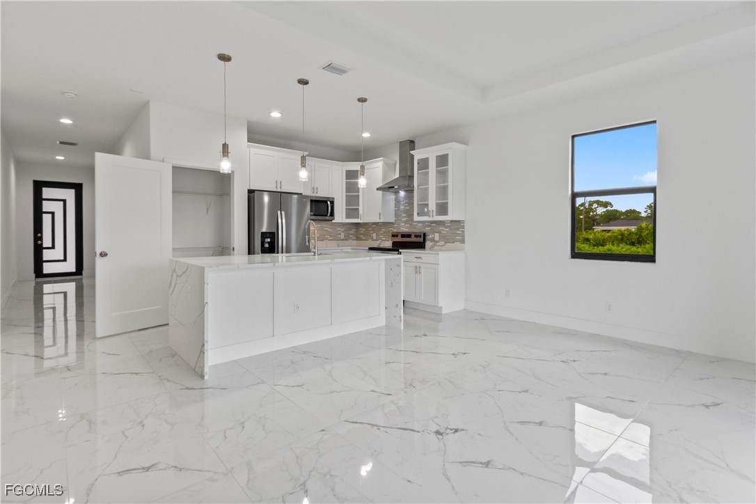 7016 Tide Circle LaBelle, FL 33935 - Photo 12 of 47 a large white kitchen with a stove a sink dishwasher and a refrigerator
