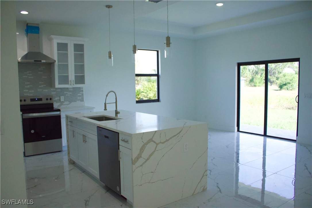 7016 Tide Circle LaBelle, FL 33935 - Photo 14 of 47 a kitchen with stainless steel appliances granite countertop a sink and a stove