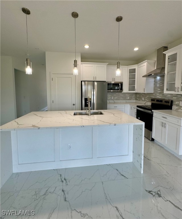 7016 Tide Circle LaBelle, FL 33935 - Photo 16 of 47 a large kitchen with kitchen island a large counter top stainless steel appliances and cabinets