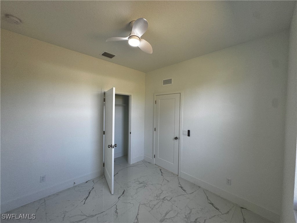 7016 Tide Circle LaBelle, FL 33935 - Photo 20 of 47 an empty room with a ceiling fan and bathroom
