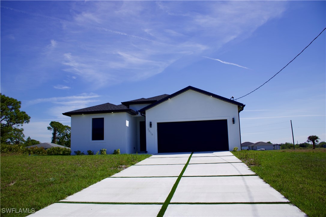 7016 Tide Circle LaBelle, FL 33935 - Photo 2 of 47 a front view of a house with a yard and garage