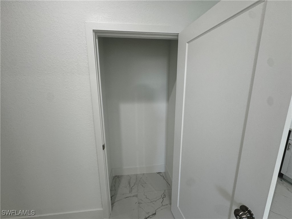 7016 Tide Circle LaBelle, FL 33935 - Photo 26 of 47 a bathroom with a glass door