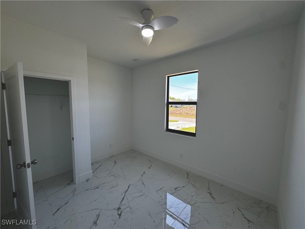 7016 Tide Circle LaBelle, FL 33935 - Photo 28 of 47 an empty room with a window and chandelier fan
