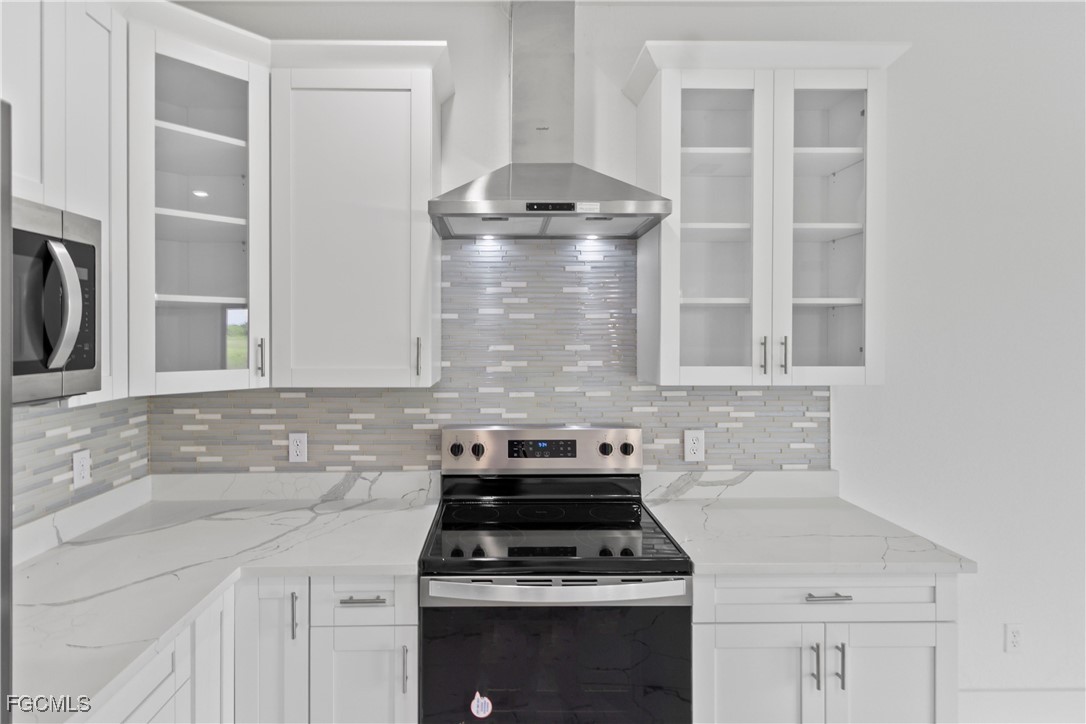 7016 Tide Circle LaBelle, FL 33935 - Photo 10 of 47 a kitchen with a stove and a white cabinet