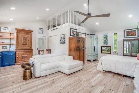 a bedroom with a bed couch and a window