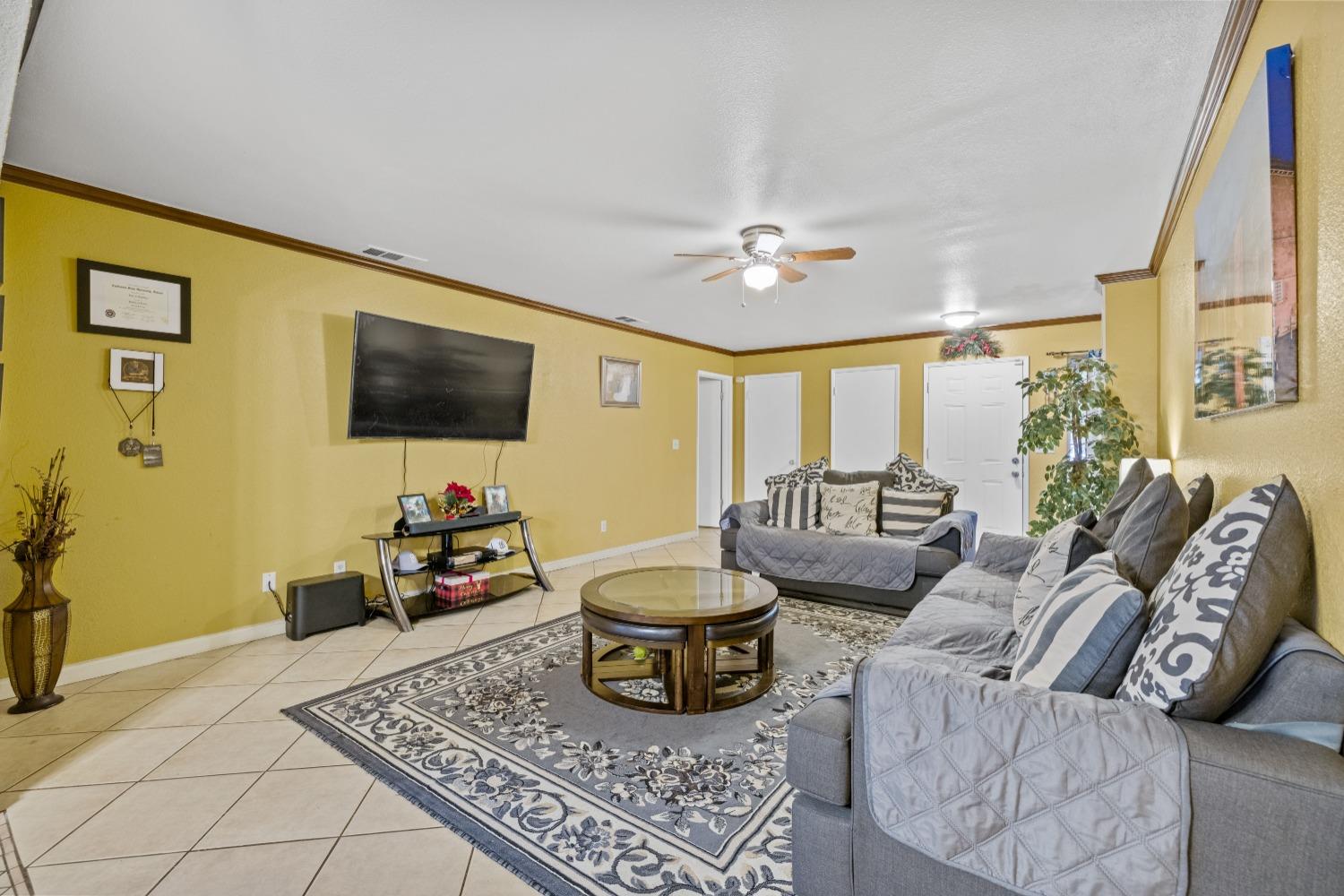 13590 9th Street Parlier, CA 93648 - Photo 13 of 30 a living room with furniture and a flat screen tv