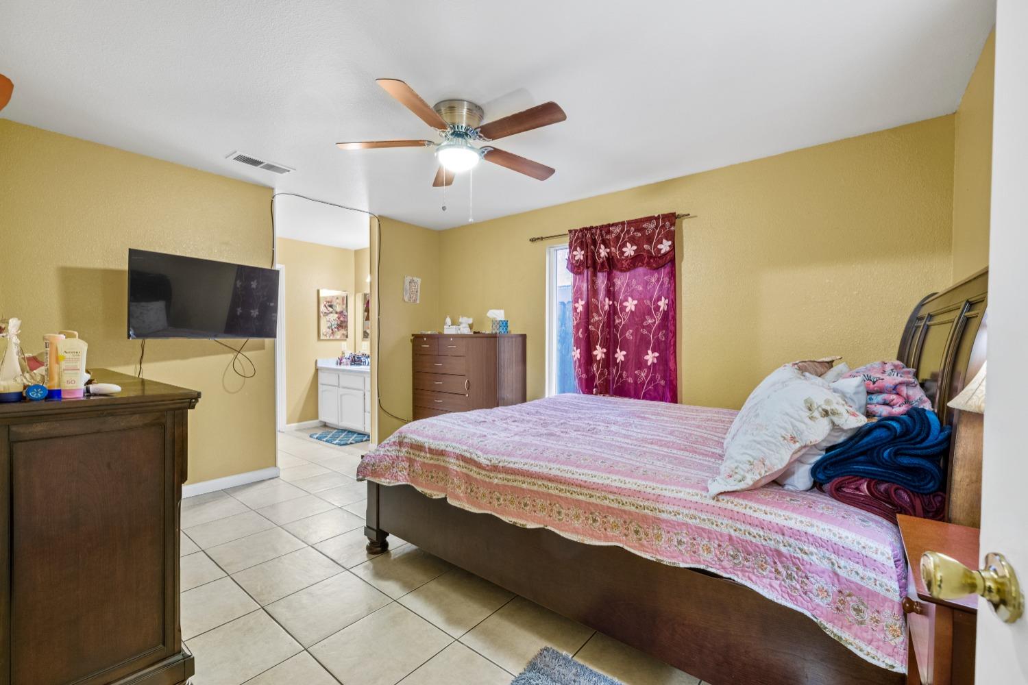 13590 9th Street Parlier, CA 93648 - Photo 14 of 30 a bedroom with a bed and a flat screen tv