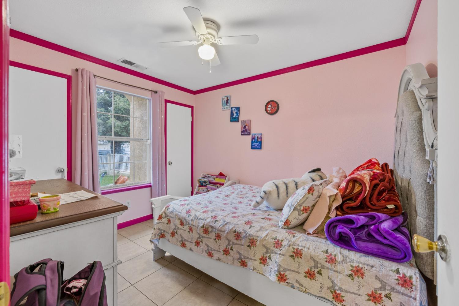 13590 9th Street Parlier, CA 93648 - Photo 21 of 30 a bedroom with a bed and a window