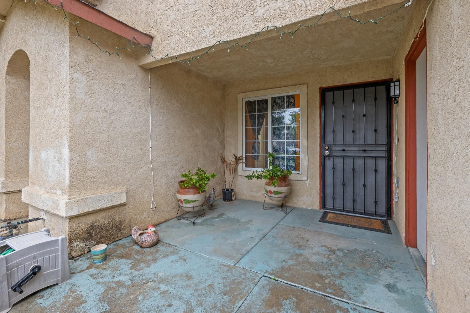 13590 9th Street Parlier, CA 93648 - Photo 4 of 30 a view of an entryway door front of house