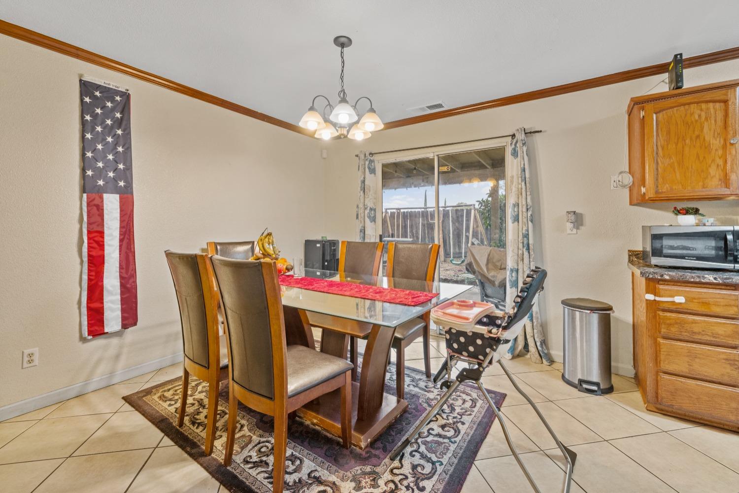 13590 9th Street Parlier, CA 93648 - Photo 8 of 30 a view of a dining room with furniture and chandelier